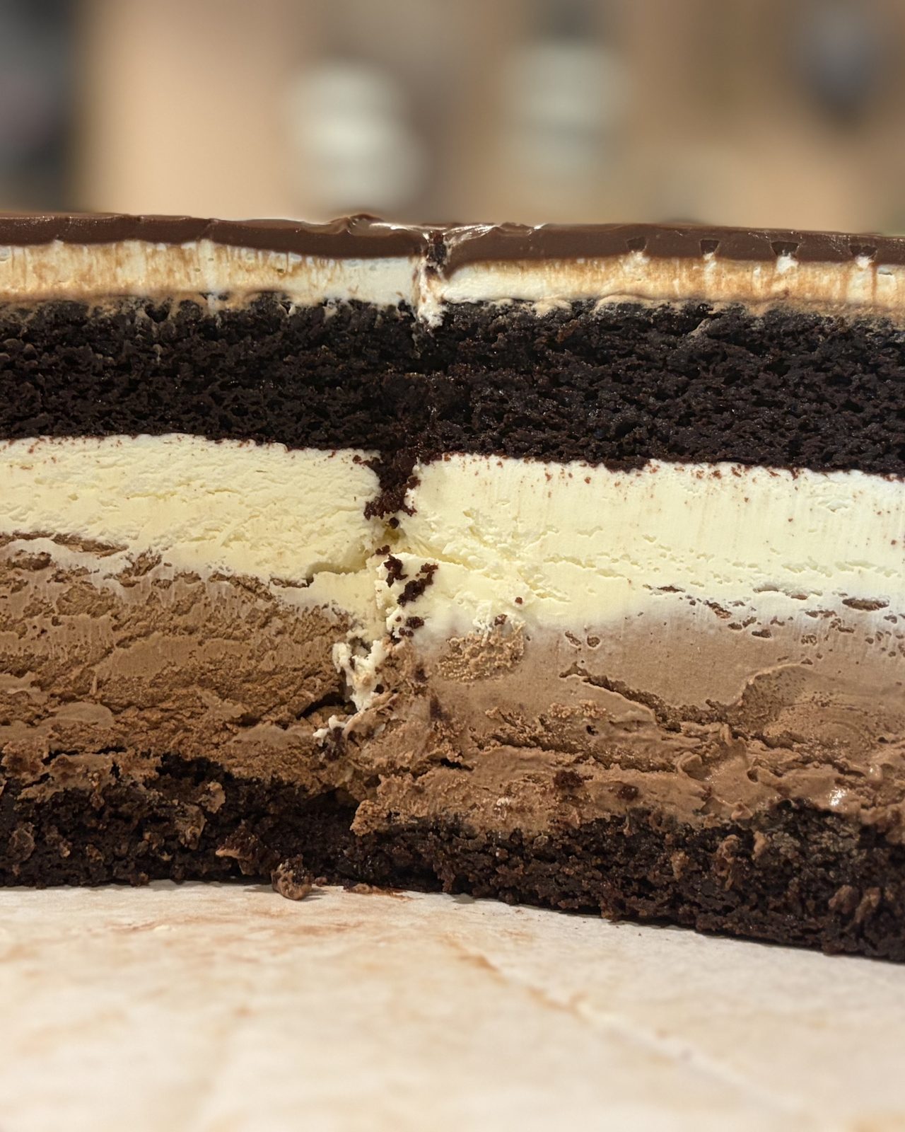Triple chocolate mousse cake, cut to show the layers